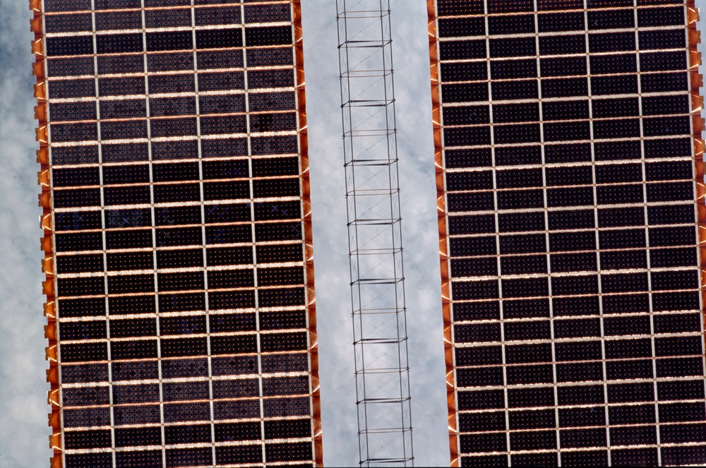 Exterior view of ISS during flyaround by STS-105 showing P6 SAW