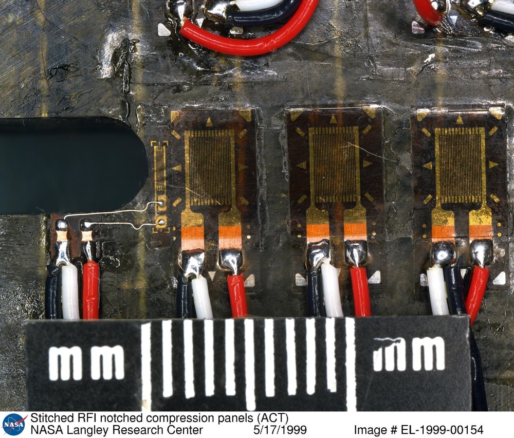 Stitched RFI notched compression panels (ACT)