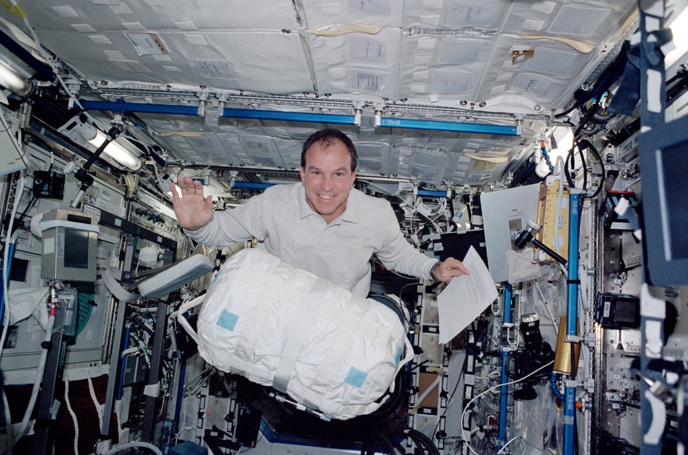 Bloomfield moves a CWC in Destiny during STS-110's visit to the ISS