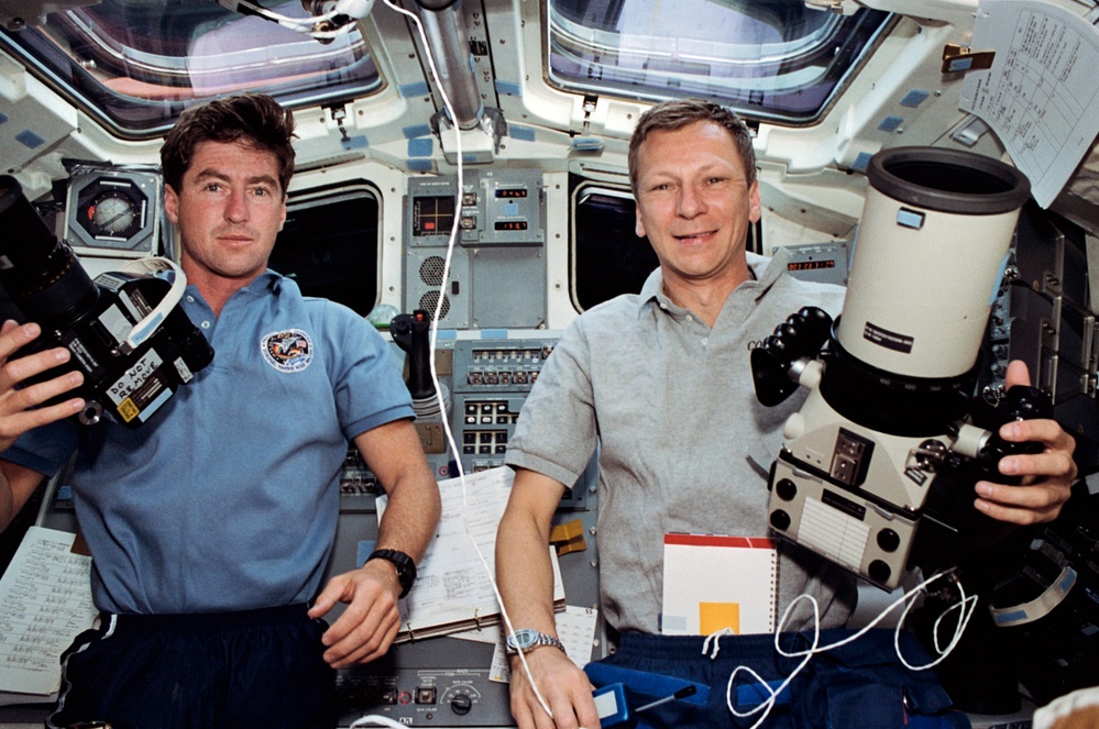 Crewmembers in the Aft Flight Deck taking photographs.