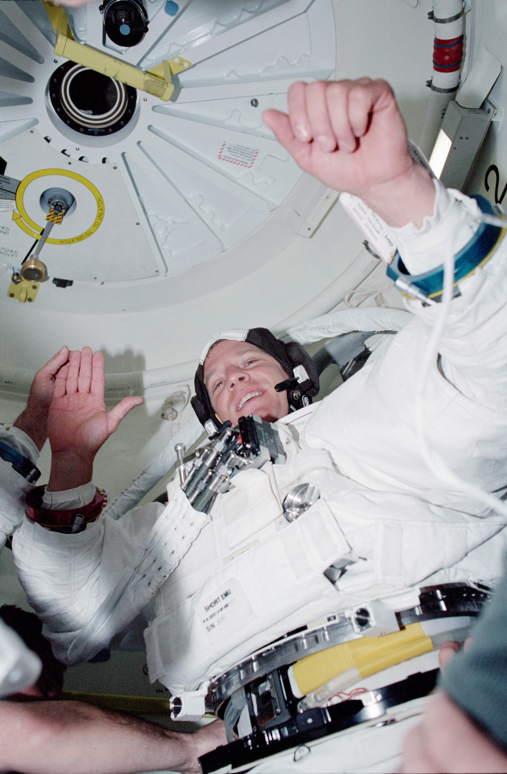 MS Parazynski is assisted into his EMU lower torso in Endeavour's airlock during STS-100