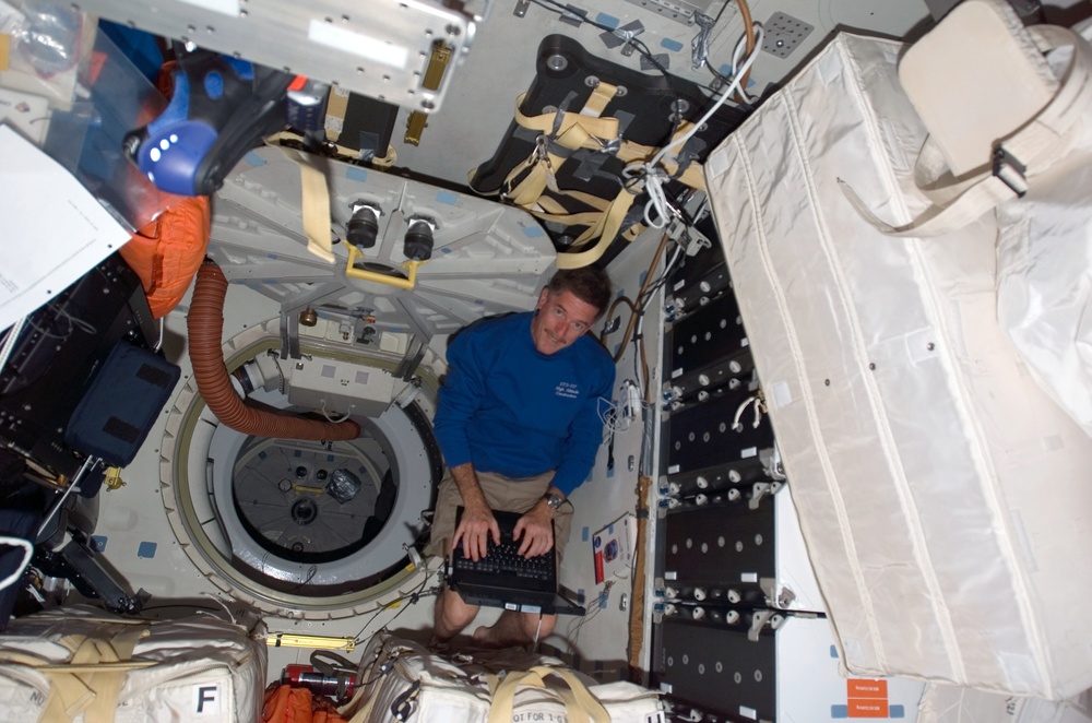 Reilly uses laptop computer on the MDDK on STS-117 Space Shuttle Atlantis