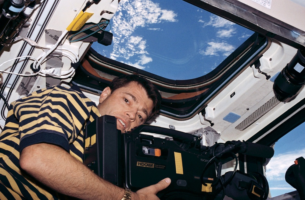 STS-93 Pilot Ashby takes video footage from the flight deck of Columbia