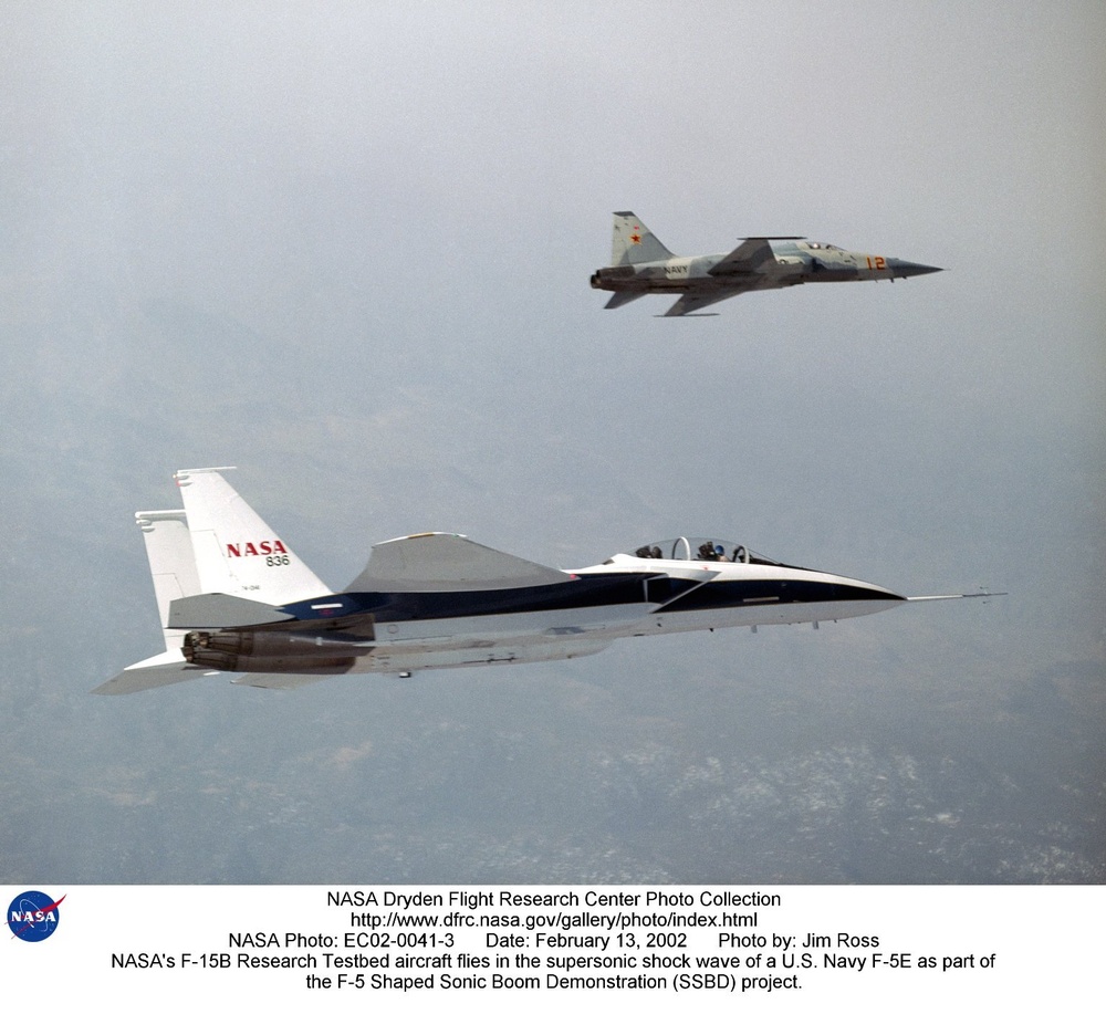 NASA's F-15B Research Testbed aircraft flies in the supersonic shock wave of a U.S. Navy F-5E as par