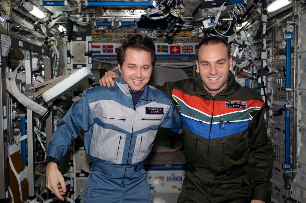 Bursch and Shuttleworth pose for a photo in U.S. Lab during Expedition Four