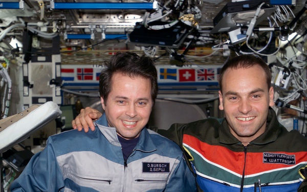 Bursch and Shuttleworth pose for a photo in U.S. Lab during Expedition Four