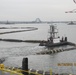 Dredged sand was used to cap or close the Newark Bay CDF. This photo shows the floating pipeline that connected the dredge to the pump barge at the CDF site.