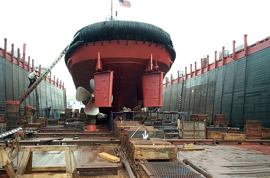 Tugboat in a dry dock for hull painting and propeller work at Caddell Dry Dock &amp; Repair Co.