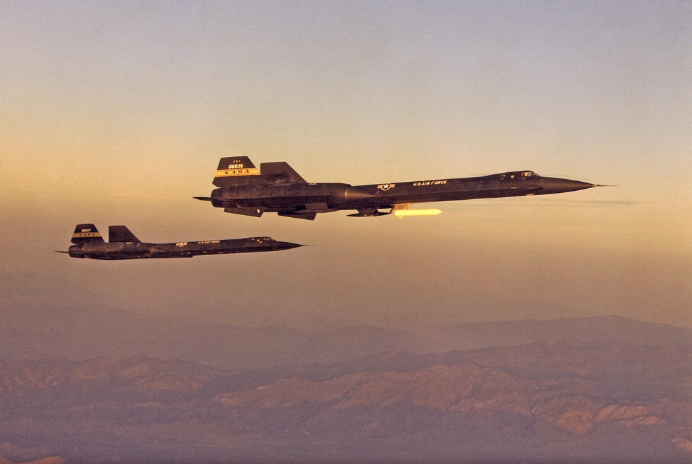 YF-12A and YF-12C in flight formation at dawn