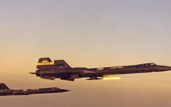 YF-12A and YF-12C in flight formation at dawn