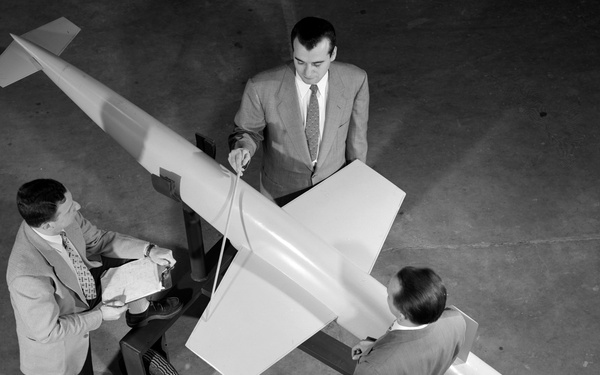 AERODYNAMICS ENGINEER WITH RAM JET NO. 2 SCALE MODEL FOR USE IN RECRUITING BROCHURE