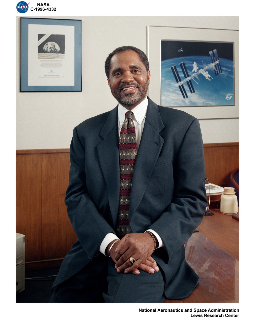 ENVIRONMENTAL PORTRAIT OF JOHN HAIRSTON IN HIS OFFICE AT DESK