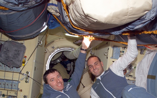 Soyuz 4 FE Vittori and SFP Shuttleworth pose in the FGB during Expedition Four