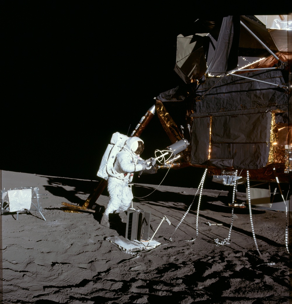 Apollo 12 Mission image  - Alan Bean unloads ALSEP RTG fuel element