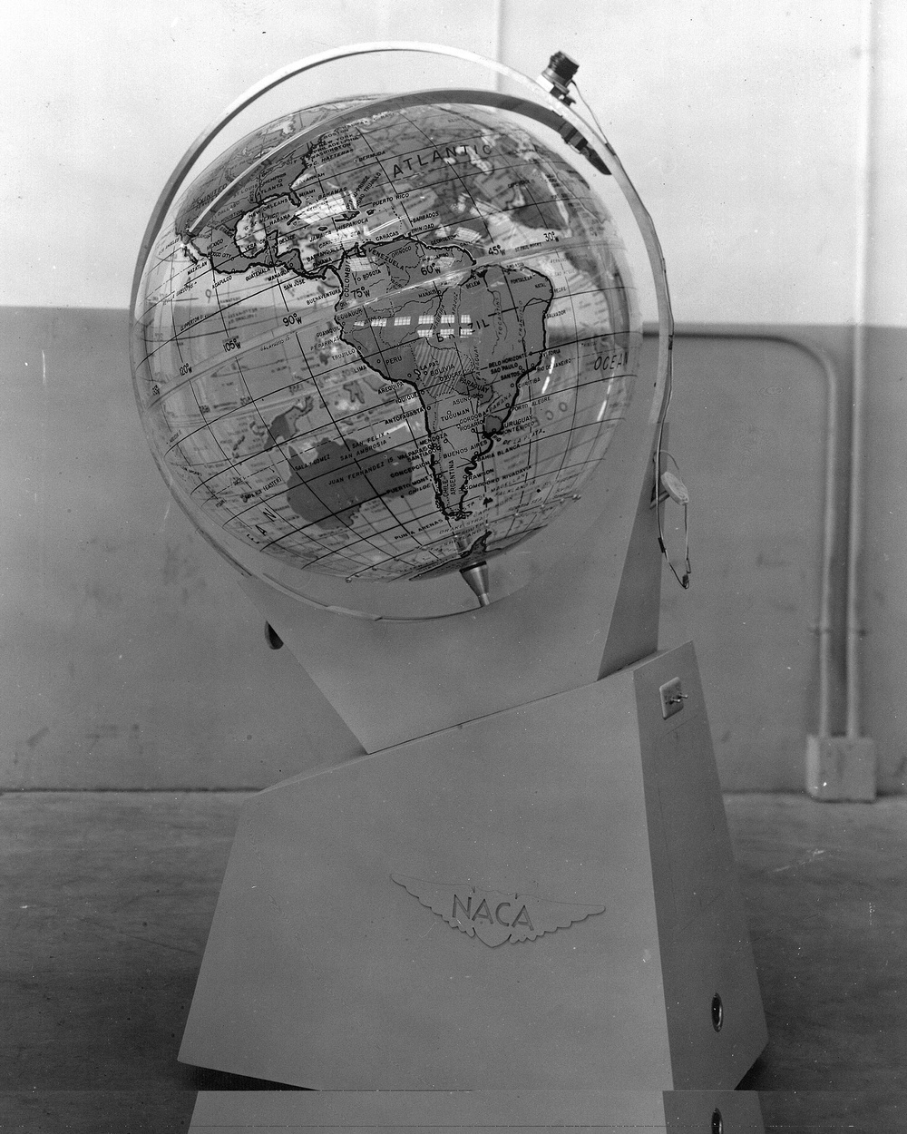 TERRESTRIAL GLOBE AND SATELLITE COPY OF AMES RESEARCH CENTER PHOTOGRAPH A-24148