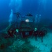 US Navy divers, alongside the Joint POW/MIA Accounting Command, search for an unaccounted-for service member who went missing during World War II