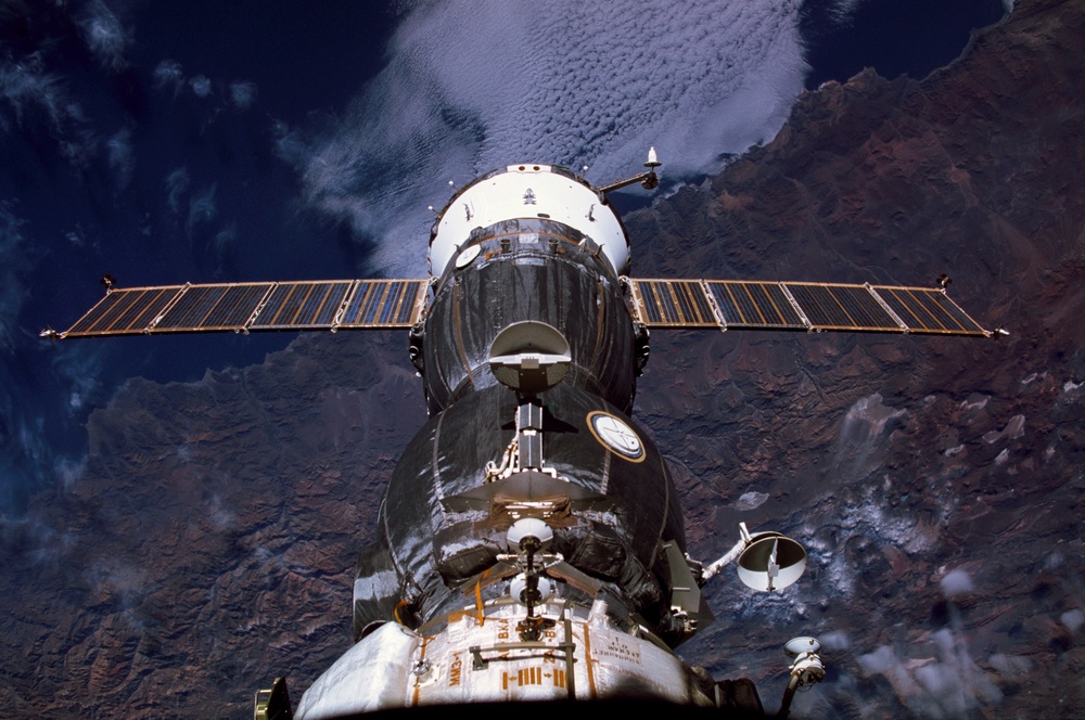 View of Soyuz with Earth view in the background taken during Expedition Six on the ISS