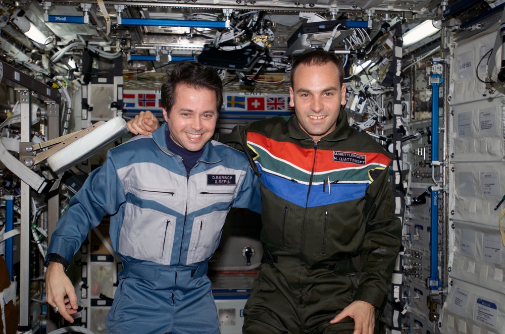 Bursch and Shuttleworth pose for a photo in U.S. Lab during Expedition Four