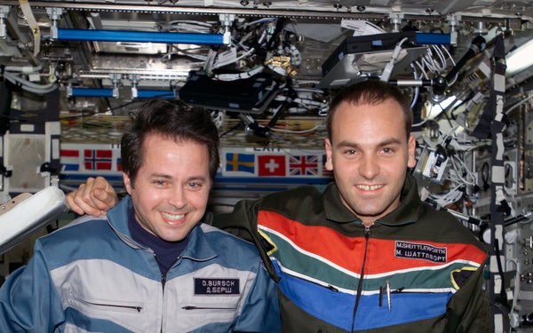 Bursch and Shuttleworth pose for a photo in U.S. Lab during Expedition Four