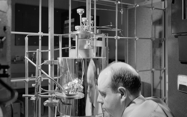 DR MYRON DAVIS WITH APPARATUS USED IN AN EXPERIMENTAL STUDY OF DIFFUSION IN OXIDES AT TEMPERATURES ABOVE 1000 DEGREES C AT THE BASIC MATERIALS LABORATORY BML BUILDING