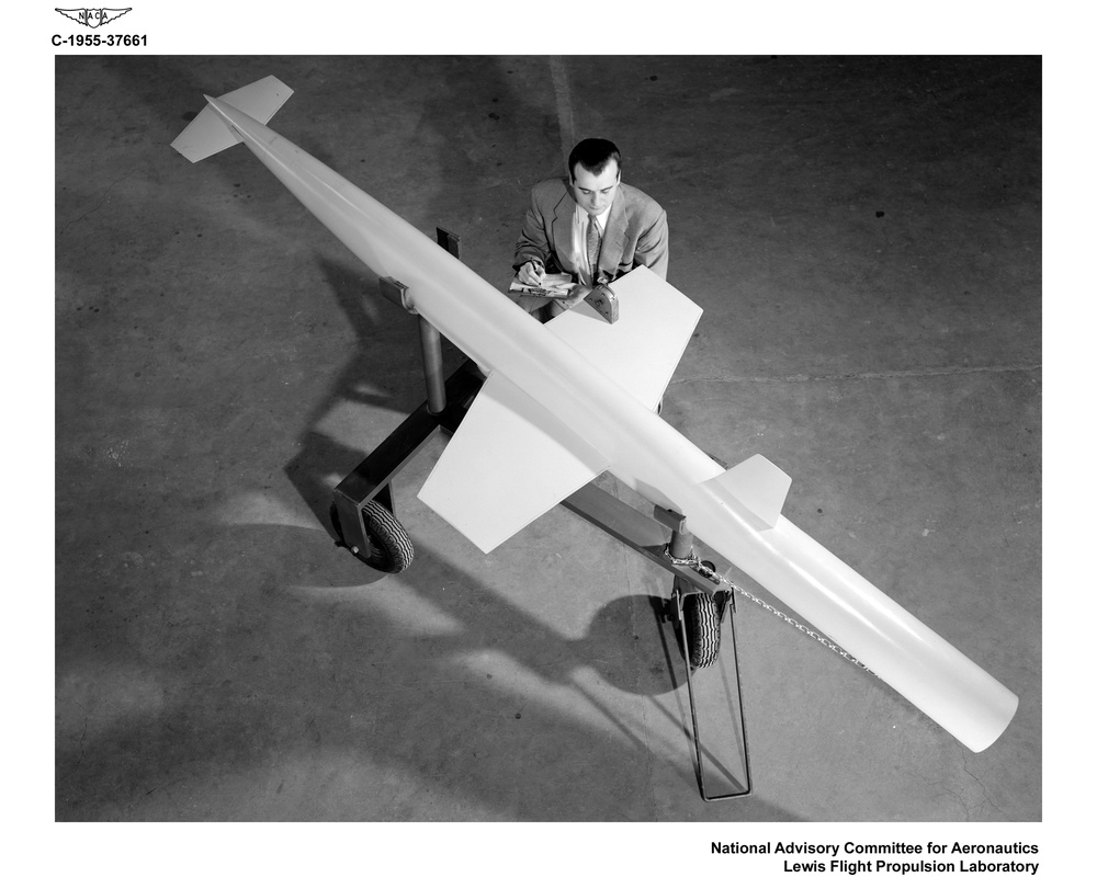 AERODYNAMICS ENGINEER WITH RAM JET NO. 2 SCALE MODEL FOR USE IN RECRUITING BROCHURE