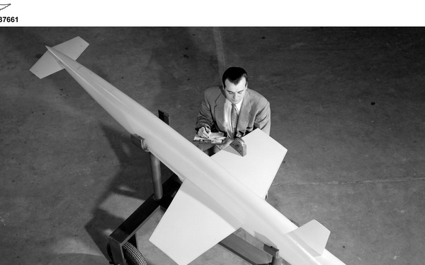 AERODYNAMICS ENGINEER WITH RAM JET NO. 2 SCALE MODEL FOR USE IN RECRUITING BROCHURE