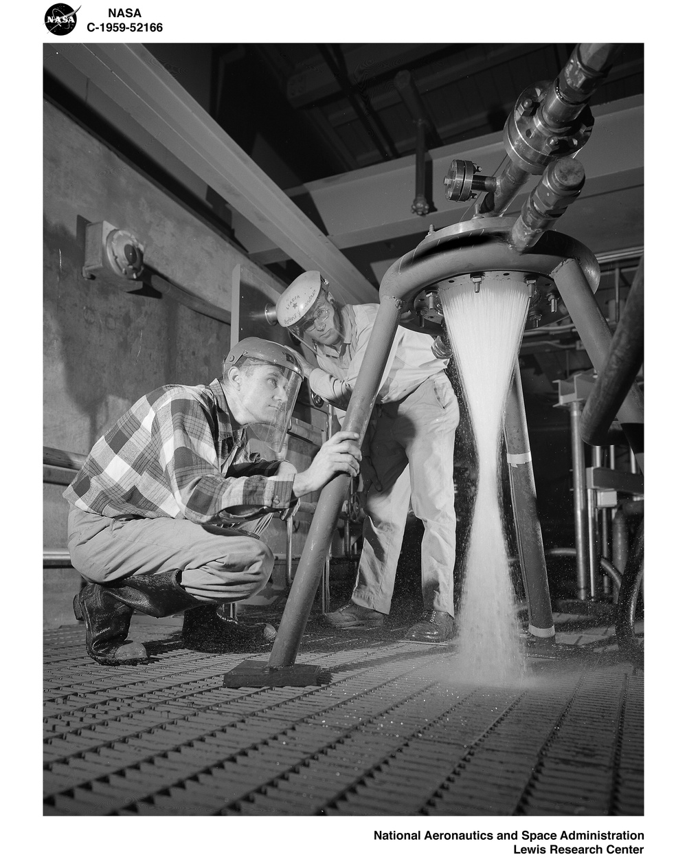 TECHNICIANS PRESSURE CHECK FUEL IMPINGING QUALITIES OF 20K POUND ROCKET INJECTOR AT THE SOUTH 40 ROCKET ENGINE TEST FACILITY RETF