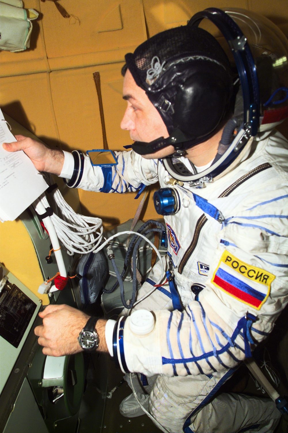 Dezhurov follows procedures in the Soyuz spacecraft during Expedition Three