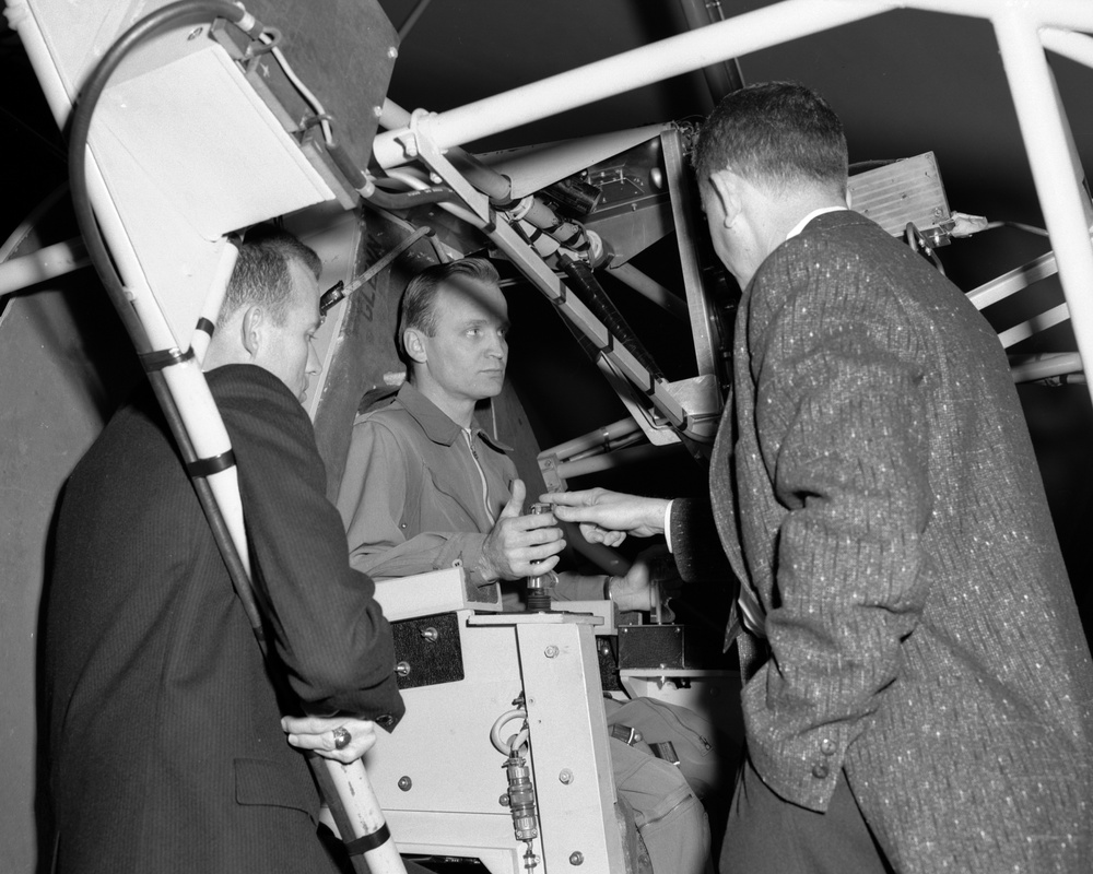 PROJECT MERCURY - ASTRONAUT LEROY GORDON COOPER JUNIOR AND WARREN NORTH NASA TESTING THE GIMBALING RIG IN THE ALTITUDE WIND TUNNEL AWT AT NASA LEWIS RESEARCH CENTER