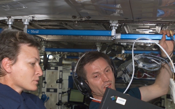 Expedition Five Flight Engineer Whitson and Treschev during on-orbit hearing assessment