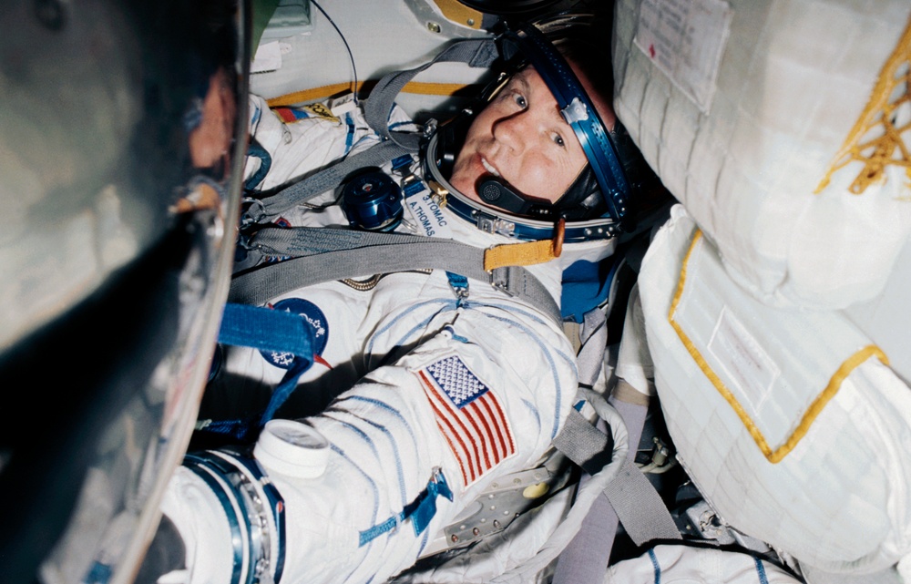 MS Thomas tries on his Sokol suit onboard the Soyuz