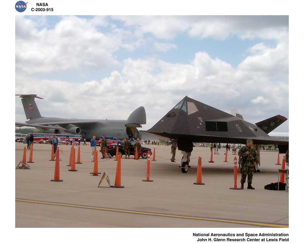 THE F-117 STEALTH BOMBER WITH A C-5A TRANSPORT (BACKGROUND) ON THE FLIGHT LINE AT WRIGHT PATTERSON AIR FORCE BASE OPEN HOUSE - AIR POWER 2003, MAY 10-11, 2003