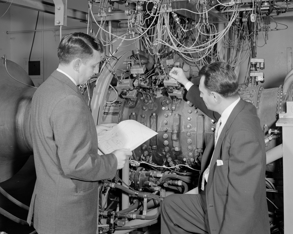 AERONAUTICAL RESEARCH SCIENTISTS ARTHUR MEDEIROS AND RICHARD GEYE AT WORK ON J-34 ENGINE WITH 5 STAGE TRANSONIC COMPRESSOR