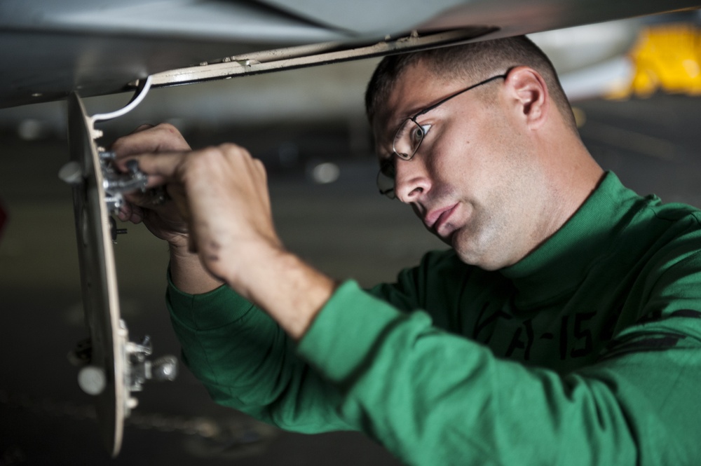 USS Nimitz crew performs aircraft maintenance