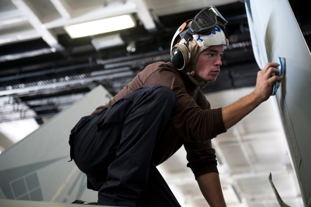 USS Nimitz crew performs aircraft maintenance