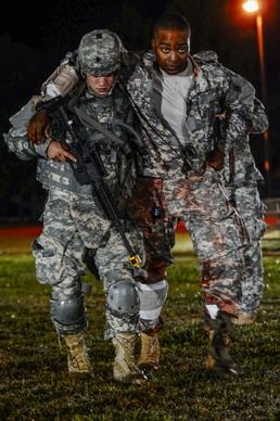 Spc. Jeremy Shivick moves a patient to the casualty collection point
