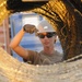 NMCB 133 Seabee helps lower wire