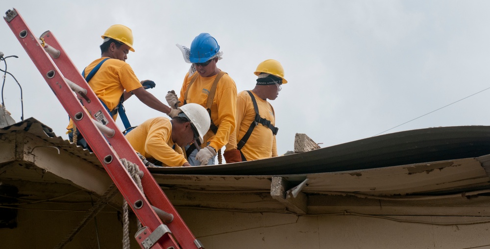 Workers assess building damage at Guantanamo Bay, Cuba