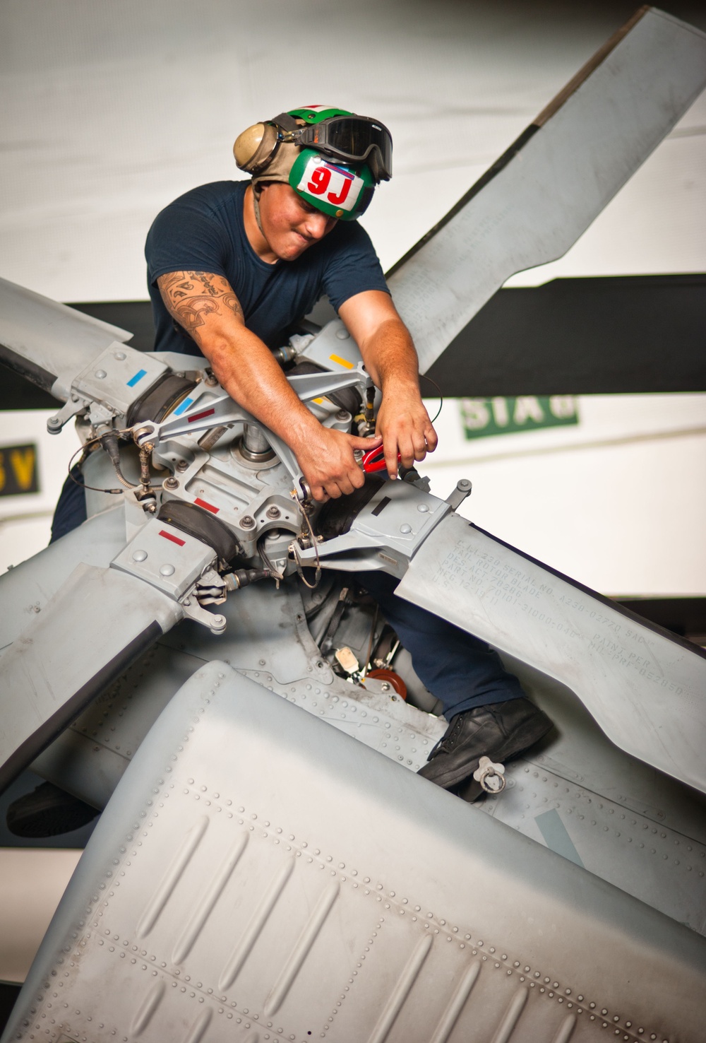 Maintenance on MH-60S Sea Hawk's rotor