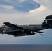 EA-6B Prowler flies over the USS Enterprise