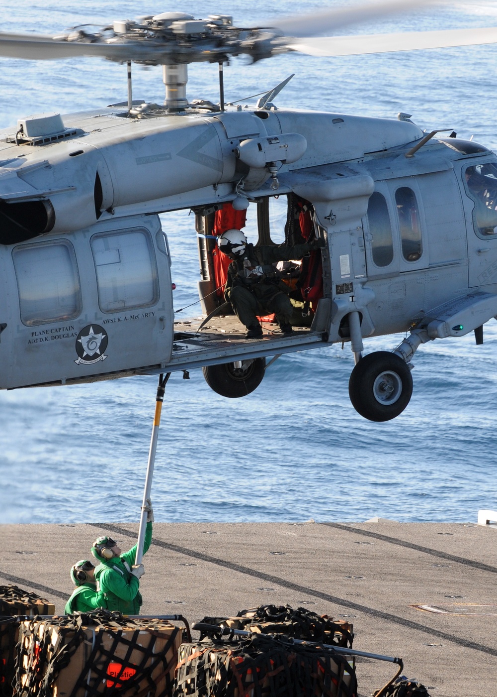 Helicopter carries cargo between ships