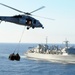 Helicopter carries cargo between ships