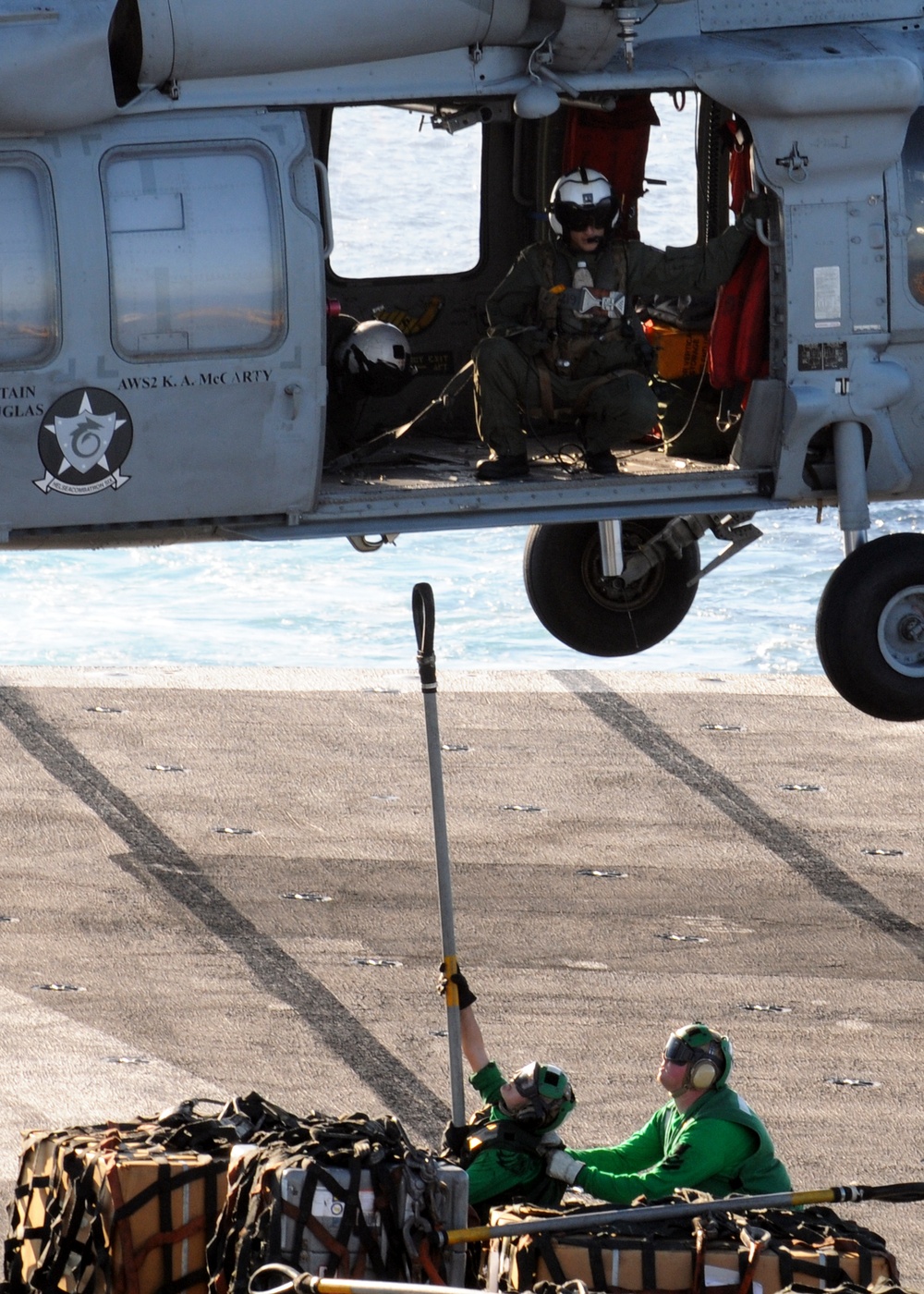 Helicopter carries cargo between ships