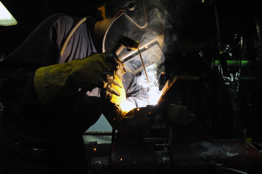 Sailor welds seam aboard USS Curtis Wilbur