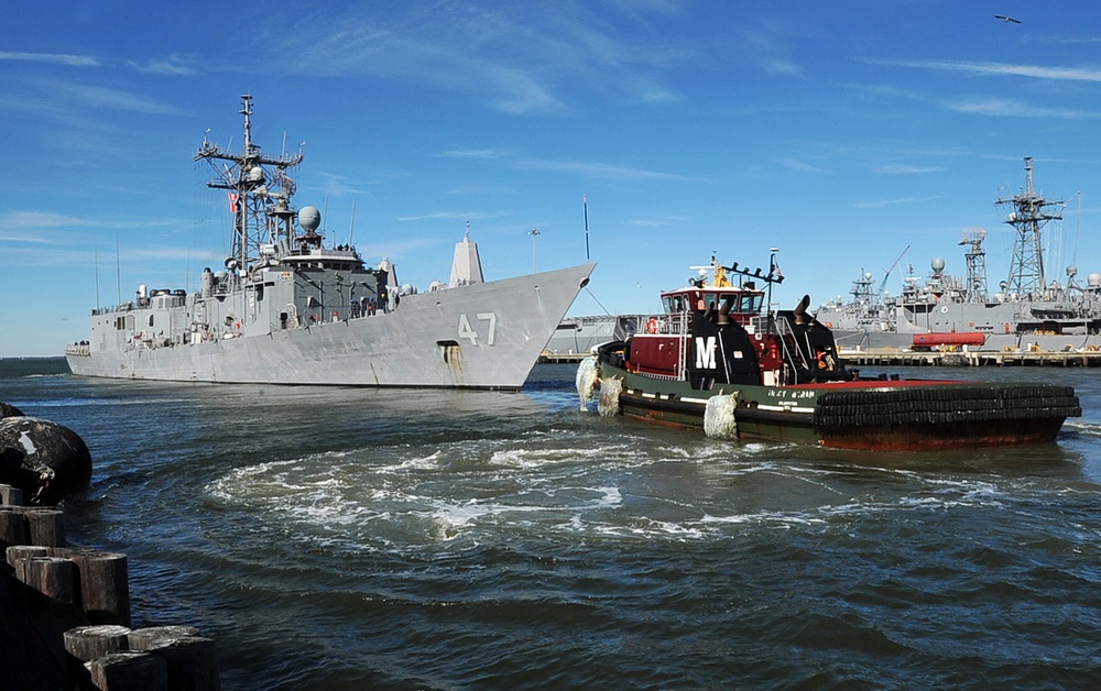 Tugboats move USS Nicholas
