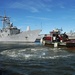 Tugboats move USS Nicholas