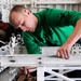 USS Nimitz crew member works in hangar