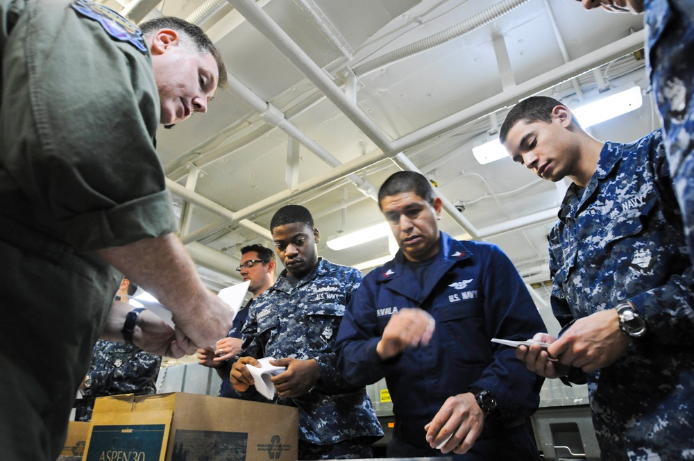 USS Nimitz sailors prepare leaflets