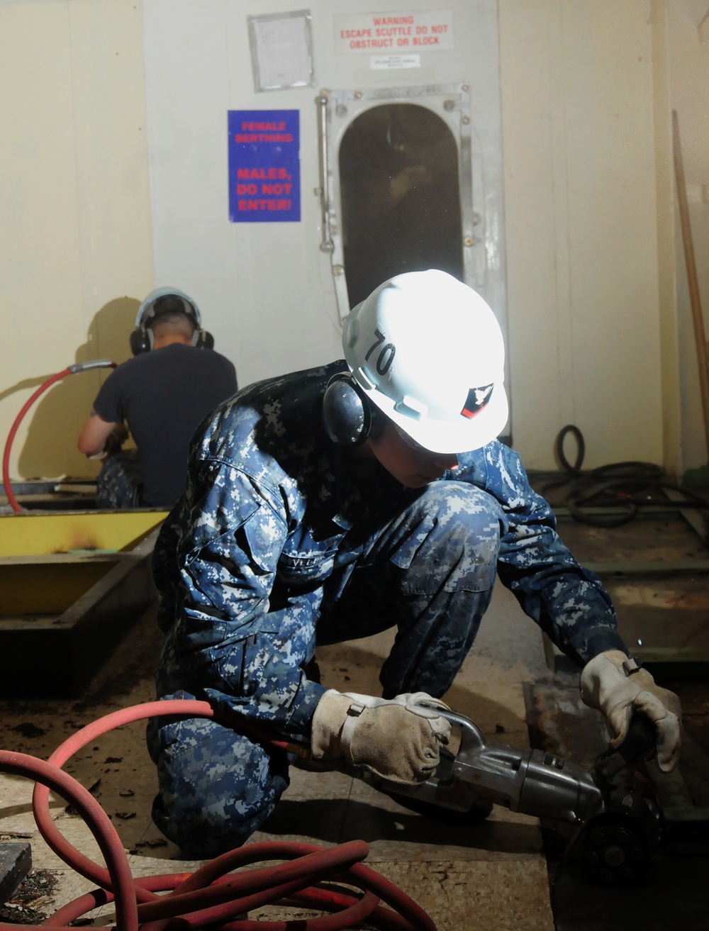 USS Carl Vinson sailor removes tar