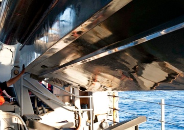 USS Fort McHenry sailor guides boat
